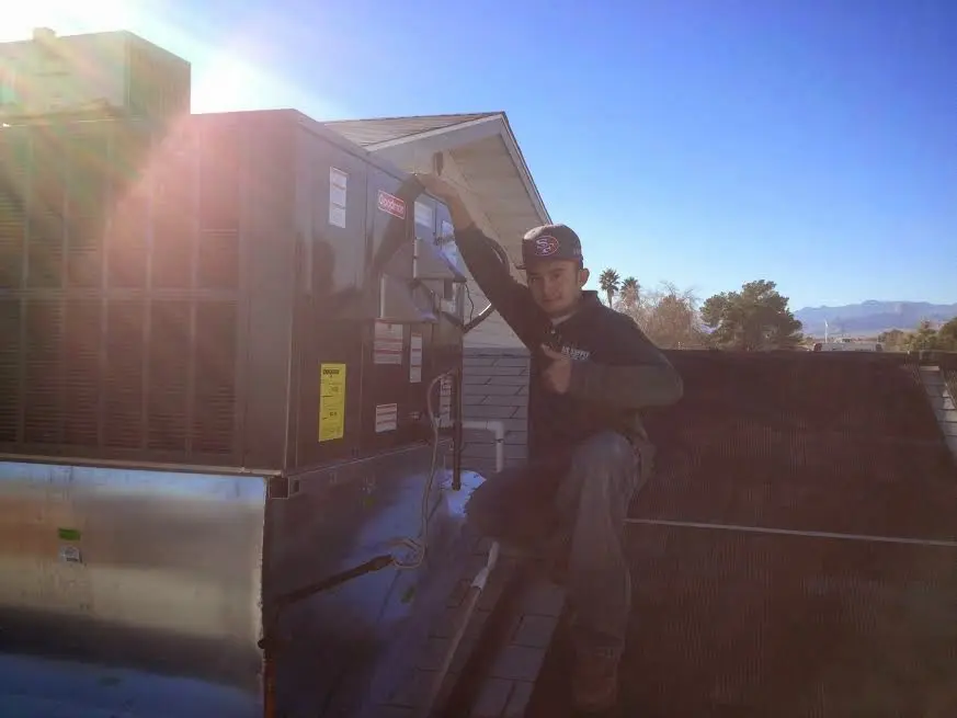 HVAC technician performing AC Tune-Up on a rooftop unit in Shaker Heights